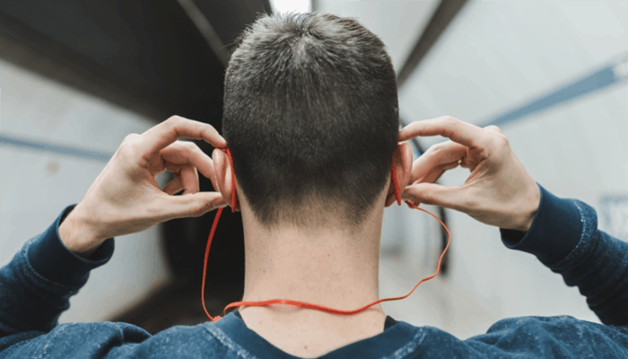 Man holding red earphones