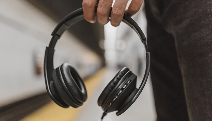 Person holding headphone