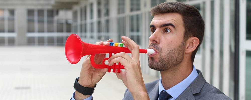 Man playing a plastic trumpet