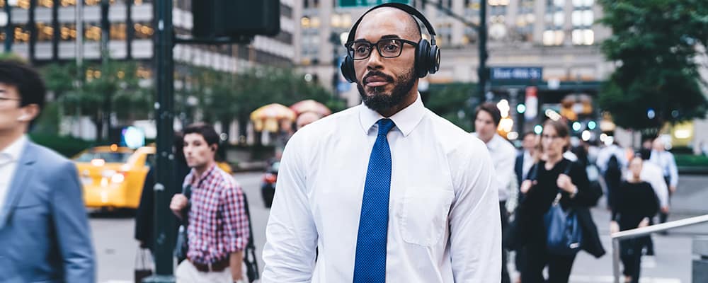 Man using wireless headphones on street
