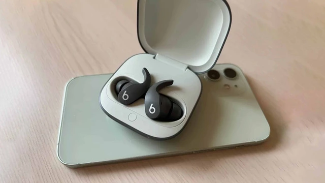 Beats earbuds next to their case