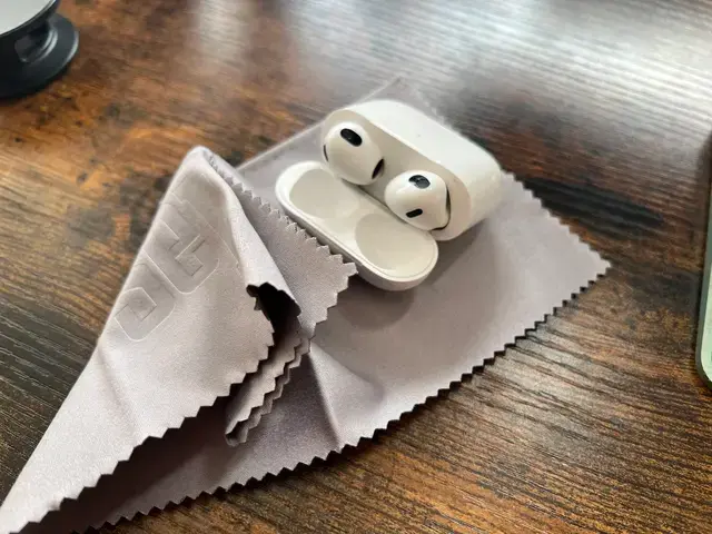 Cleaning AirPods with a soft cloth
