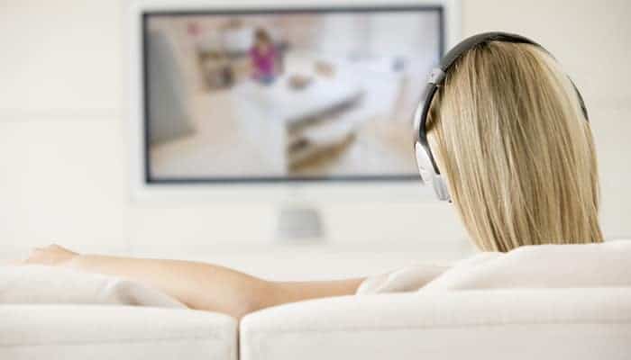 Woman in living room watching tv