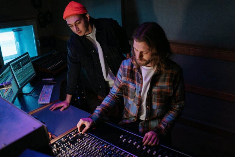 men in the recording studio in front of the best multi track recorder