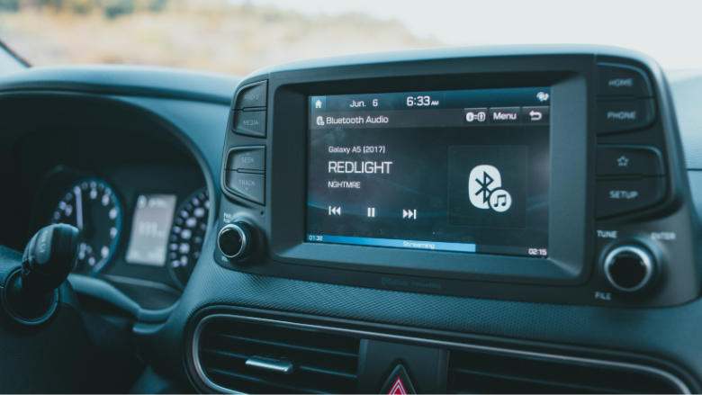 car stereo displaying song and bluetooth audio