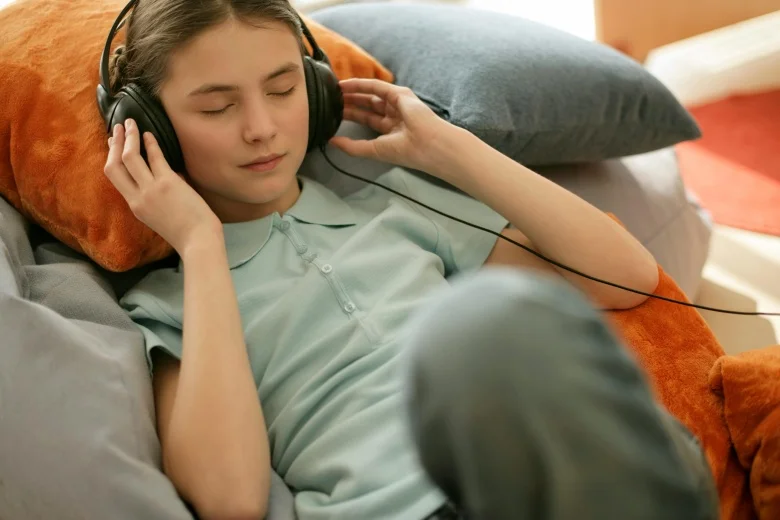 girl in green shirt listening to music