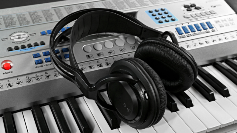 headphones placed on a synthesizer keyboard