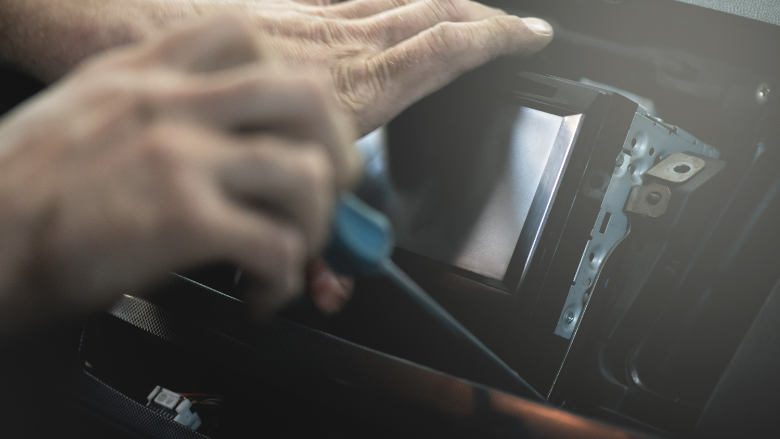 person installing car stereo