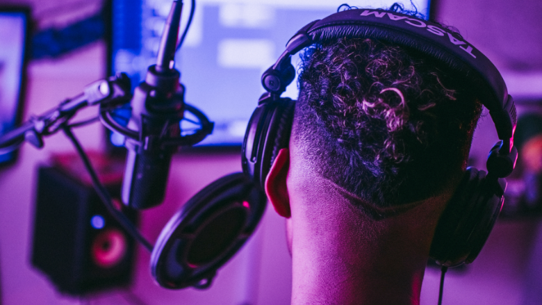 person wearing headphones in recording studio