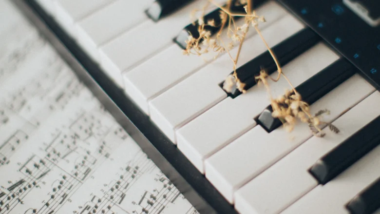 sheet music and piano keys with dried flowers