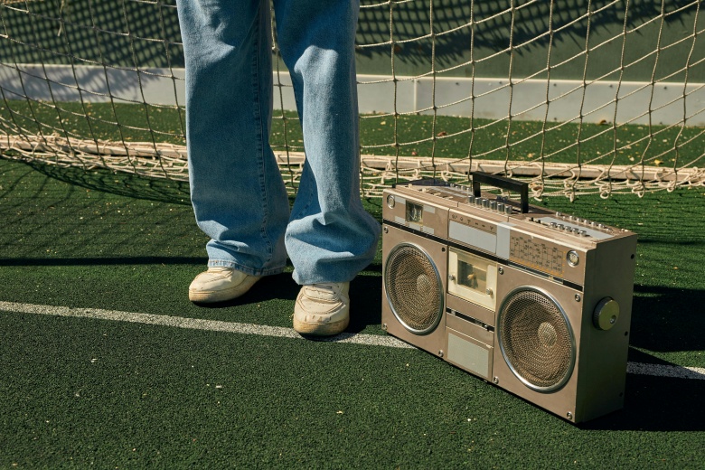 vintage boombox on the ground by a soccer net