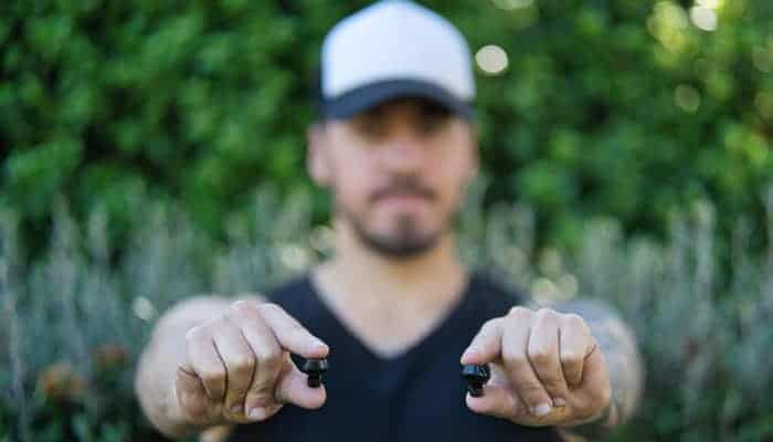 Man with pair of wireless earbuds