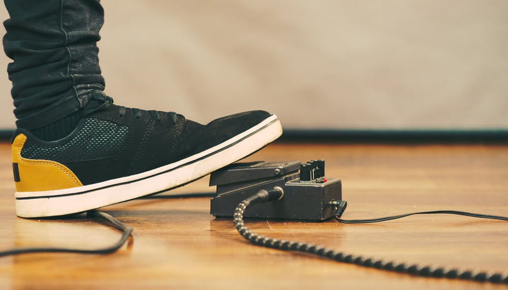 Man stepping on guitar pedal