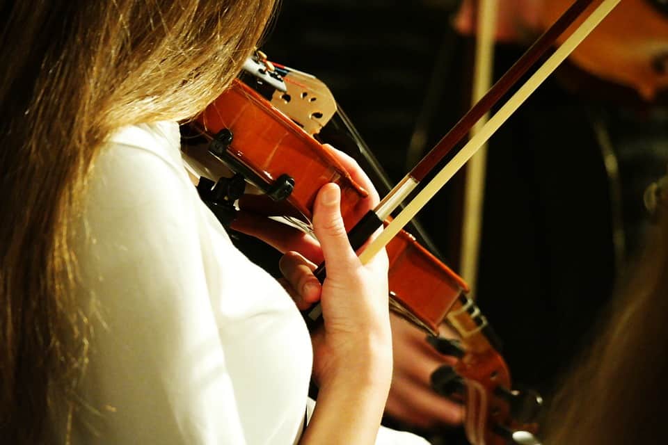 Girl plucking violin strings