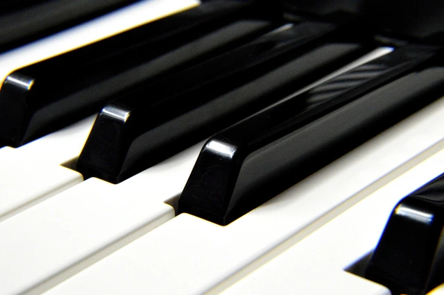 A close-up shot of a typical 88-key piano with a focus on black and white keys.