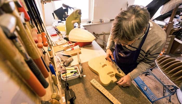 Man repairing electric guitar