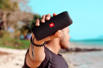 Man holding up a JBL Bluetooth speaker