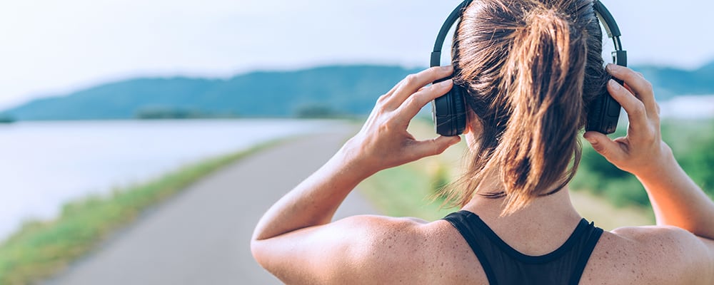 Girl adjusting wireless headphone