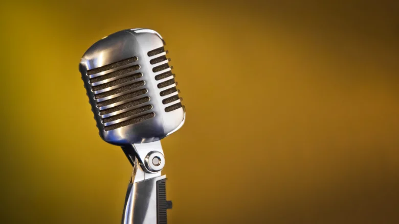 classic vintage microphone with yellow background