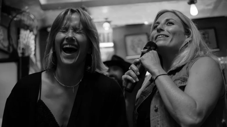 two women laughing and singing best karaoke machines