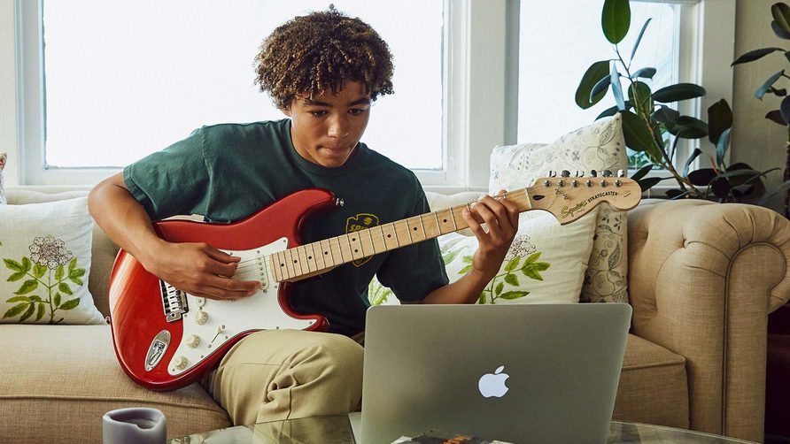 boy-learning-guitar-on-fender-play